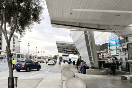 Cars pulling in at the loading and unloading curb by San Jose airport
