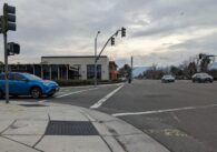 An intersection along Bollinger Road in Cupertino with cars and a stoplight.