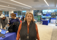 Elderly woman standing in small convention hall