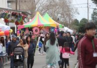 A crowd of people walks outside at a Lunar New Year festival in San Jose.