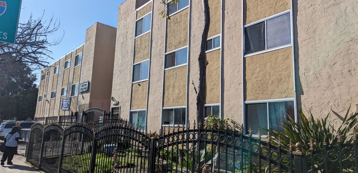The exterior of an apartment building that will be demolished for a 25-story residential tower.