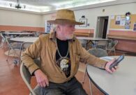 Ron Hilla, a homeless bearded man in a cowboy hat and tan jacket at a table in St. Luke's Episcopal Church in Los Gatos.