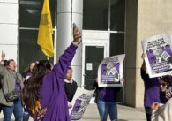 Union members holding signs in protest outside San Jose City Hall