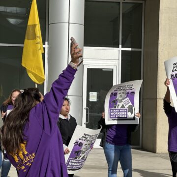 Cohen Fast Food Workers Union members holding signs in protest outside San Jose City Hall
