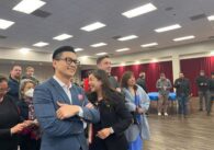 A crowd of people watching election results come in on election night