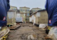 Modular homes under construction in San Jose covered in tarps to eliminate mold.