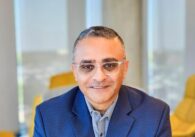 A man in a suit and sunglasses