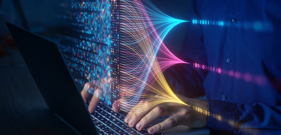 Multicolored lights hover above hands typing on a keyboard