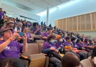 A crowd of people in seats at a San Jose City Council meeting