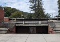 A photo of the entrance to Los Gatos Town Hall, with stairs leading down to the Council Chambers and Planning, Building and Finance department, and stairs leading up to the police department and town hall.