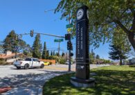 The welcome sign in front of Homestead High School in Cupertino, on Homestead Road as cars pass.