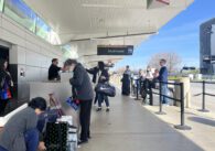 People outside a terminal at San Jose Mineta International Airport