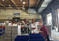 Santa Clara County election workers sort ballots in a warehouse for a recount effort