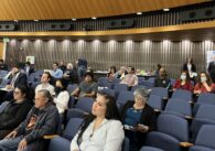 A crowd of people in the audience in the Santa Clara County Board of Supervisors chambers