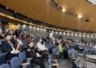 A crowd of people sit in the chambers of the Santa Clara County Board of Supervisors during a public meeting