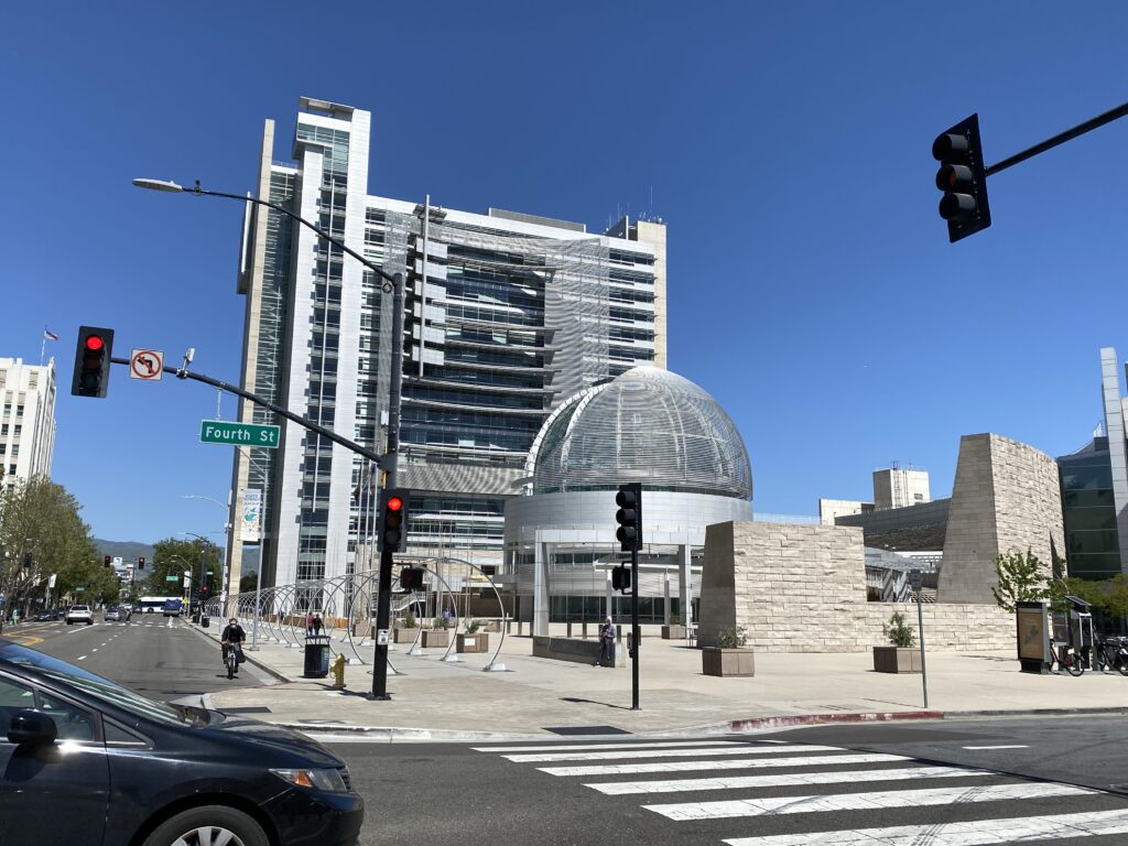 San Jose City Hall rotunda and building behind Fourth Street intersection lights