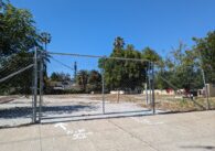 An empty, abandoned parking lot where a senior affordable housing development will go.