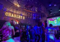 A photo of a crowd of people on the dance floor of a nightclub