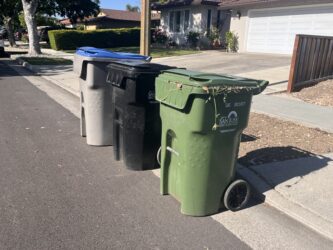 SJ GARBAGE RATES Three garbage cans on the street in San Jose, California