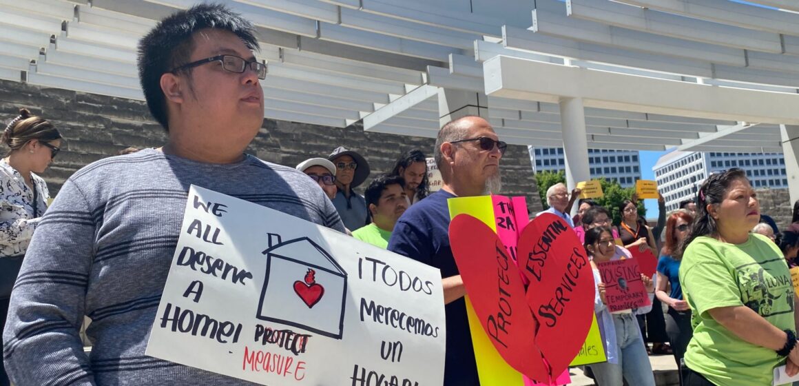 Measure E rally 5/14/24 Protesters stand with signs outside San Jose City Hall