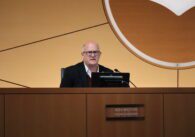 Russ Melton, white-haired man with glasses, sitting in the Sunnyvale City Hall council chambers