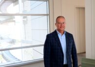 Man standing in San Jose City Hall hallway in front of window