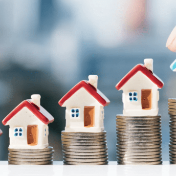 Houses stacked on columns of coins