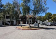 An office building's parking lot with the office building in the background