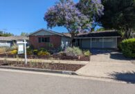 A single-story house on a residential street in Cupertino. A sale pending sign is posted outside