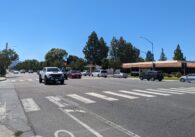 A busy intersection in Cupertino with cars coming down the street