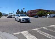 A busy intersection in Cupertino with cars coming down the street