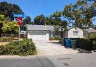A single-story, gray house in a residential neighborhood in Cupertino on Scofield Drive