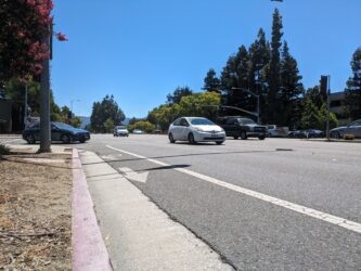 Photo of an unprotected bike lane on a busy street with cars in Cupertino