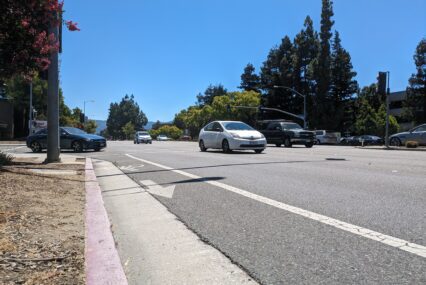 Photo of an unprotected bike lane on a busy street with cars in Cupertino