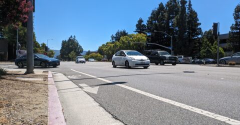 Photo of an unprotected bike lane on a busy street with cars in Cupertino