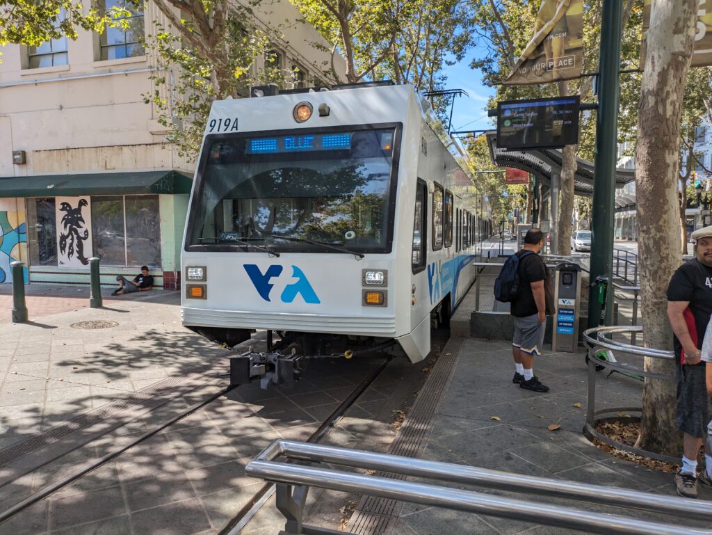 A light rail train running through downtown San Jose