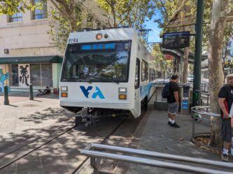 A light rail train running through downtown San Jose