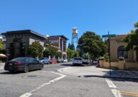 Campbell's small downtown, with cars driving down the street next to a Greek restaurant and its iconic water tower.