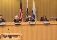 Members of the San Jose City Council sit at the dais in the council chambers