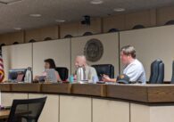 Two men and one woman sit behind a dais at Campbell City Council
