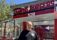 Man standing in front of a hamburger restaurant
