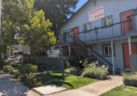 The outside of a two-story apartment building with orange doors in Campbell.