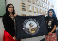 Muwekma Ohlone Tribal members Cynthia Arellano (left) and Corina Arellano holding up their tribe flag outside City Council Chambers Aug. 27, 2024