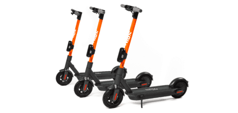 Spin brand e-scooters parked upright. Photo courtesy of Spin.