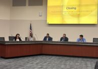 A group of people sitting at a dais
