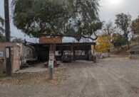 A horse stable, with a sign reading "Welcome to Bear Creek Stables"