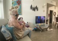 Elderly woman with dog inside an apartment