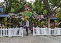 The entrance to Christmas in the Park, with a sign that has a teddy bear.