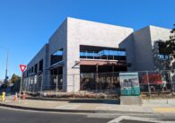 A brick building facade under construction on a street corner