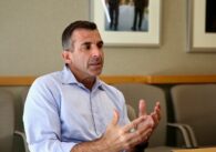 Middle-aged man sitting and gesturing while speaking